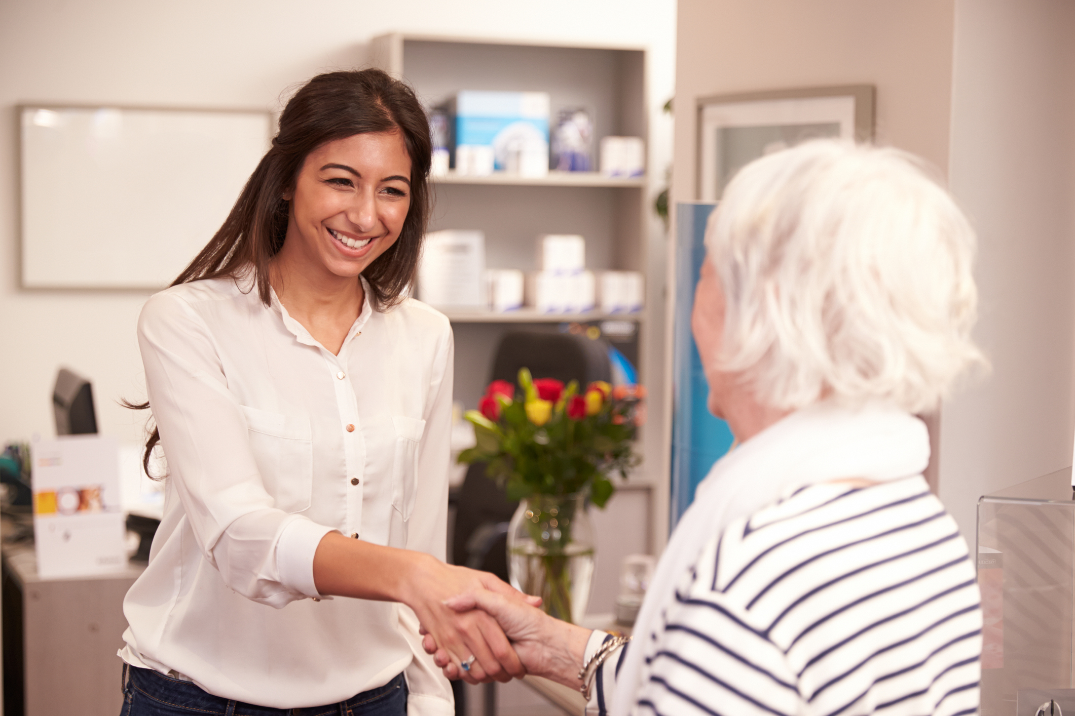 Female Physician Greeting Elderly Woman